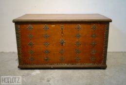 AN ANTIQUE COLONIAL TEAK TRUNK