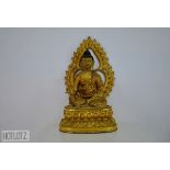 A LARGE GILT SITTING BUDDHA