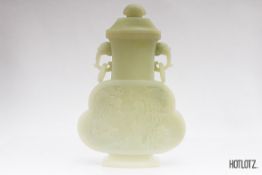 A CHINESE JADE TWIN HANDLED VASE AND COVER