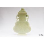 A CHINESE JADE TWIN HANDLED VASE AND COVER
