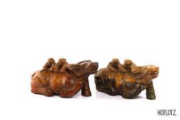 A PAIR OF CHINESE CARVINGS OF BOYS RIDING OX