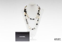 CHANEL - A FAUX PEARL AND CRYSTAL SAUTOIR