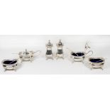A silver double cruet comprising:- two pepperettes, two salts and two mustards with spoons -