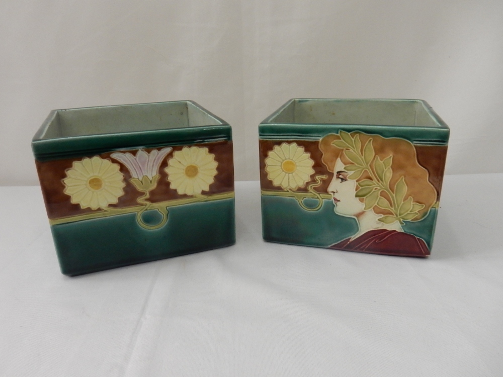 A pair of Art Nouveau style Continental porcelain vases of square form with tube lined decoration of