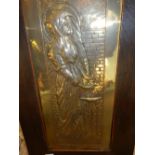 An Arts and Crafts repousse decorated brass panel depicting a pre-Raphaelite maiden initialled, in a