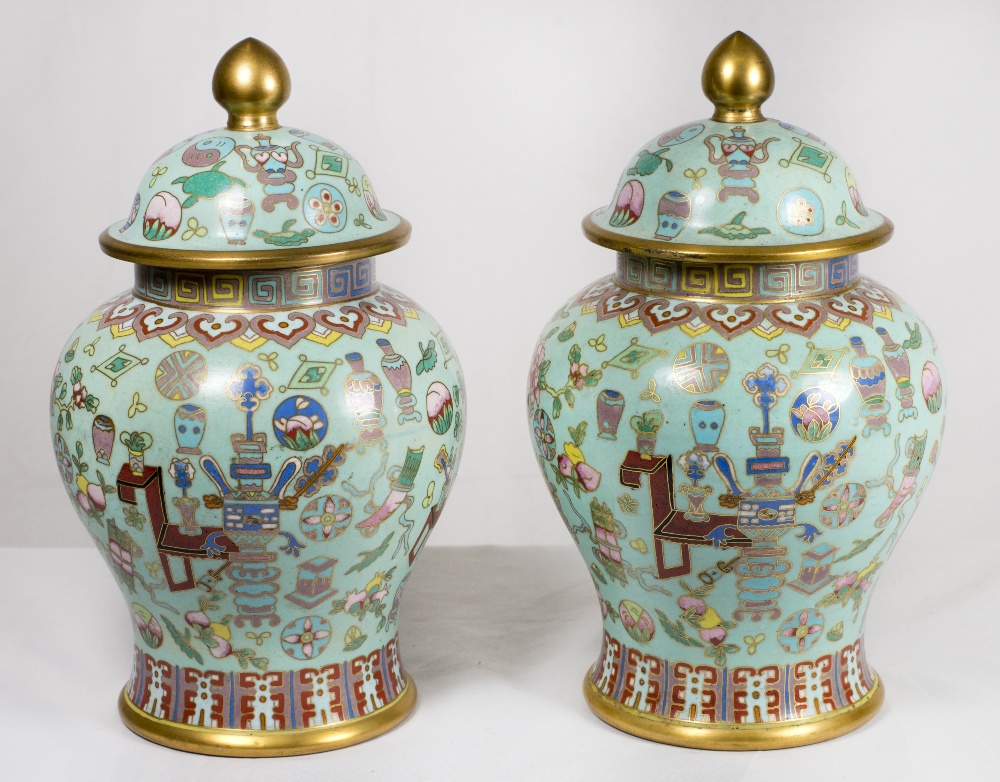 A pair of Cloisonne covered vases, turquoise ground decorated all round with precious items and