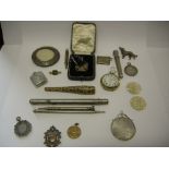 A lady's pocket watch in a gold coloured metal case, a silver Marie There Thaler, mounted, a