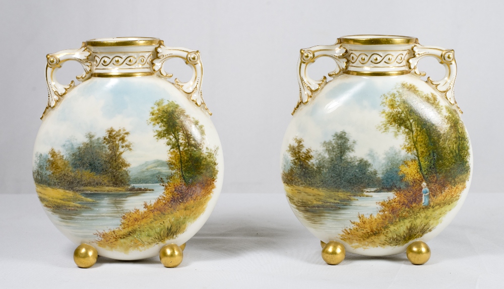 A pair of small Royal Worcester moon shaped vases with gilt handles, the bodies painted river