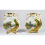 A pair of small Royal Worcester moon shaped vases with gilt handles, the bodies painted river