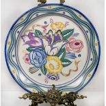 A Carter, Stabler and Adams Poole Pottery dished charger painted flowers to the centre within a wavy