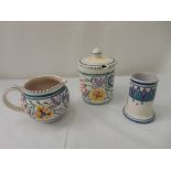 A Poole Pottery vase, cream jug and sugar basin decorated in typical colours and a Carter, Stabler