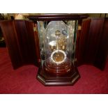 A modern German brass orrery clock with white enamel chapter ring, quartz regulated with month and