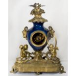 A 19th Century mantel clock with white enamel dial, in a blue porcelain case with gilded rams head