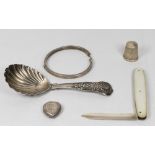A George IV silver caddy spoon with shell pattern bowl and handle - London 1827, a silver thimble, a