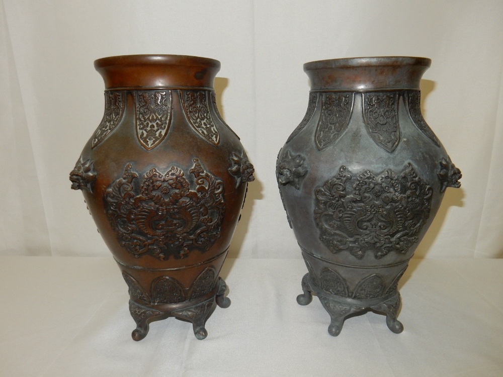 A pair of Eastern bronze vases of baluster form with stylised leaf decoration to the necks, mask