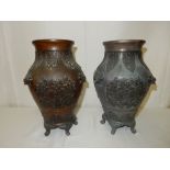 A pair of Eastern bronze vases of baluster form with stylised leaf decoration to the necks, mask