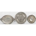 An Eastern silver coloured metal small tray with pierced decoration of a tiger and figure to the