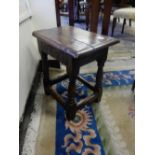 An antique oak joint stool with carved frieze, on turned legs and block feet united by straight