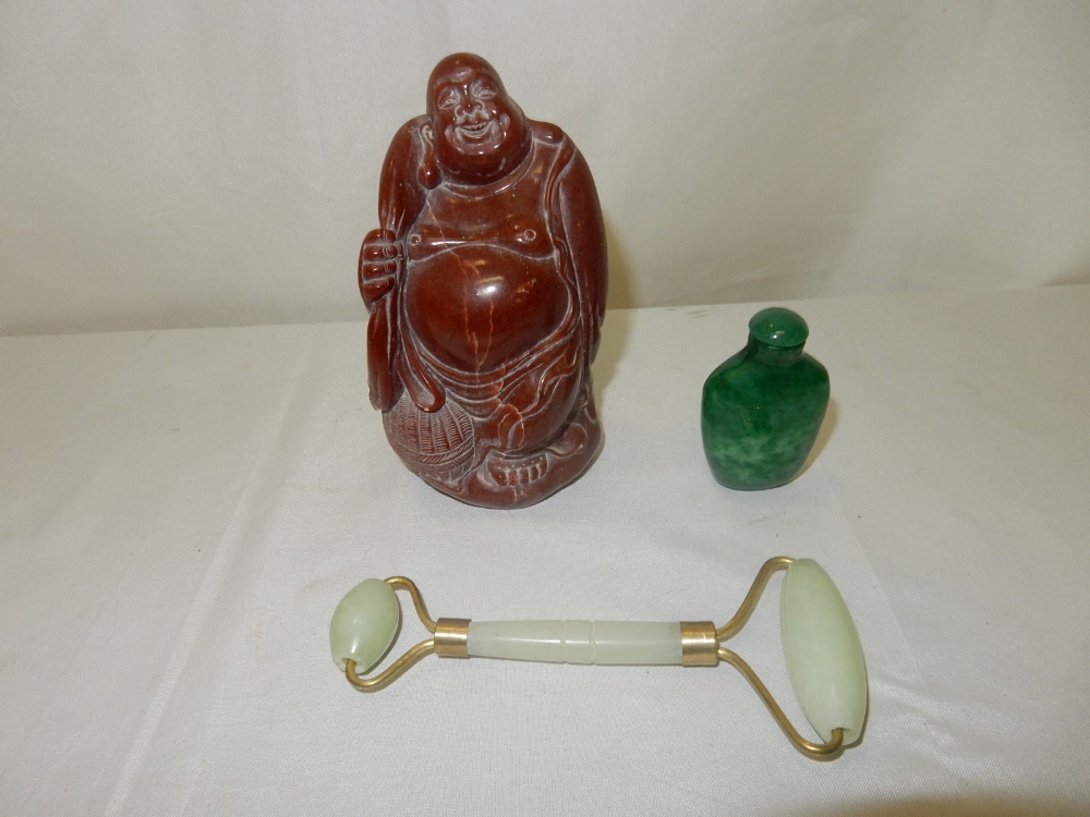 A 19th Century carved soapstone figure of a Chinese Immortal, a green hardstone snuff bottle and a