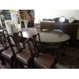 A mahogany dining table with oval top, gadroon border, two extra centre leaves, on cabriole legs