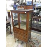 An Edwardian mahogany and satinwood inlaid display cabinet fitted two glass doors, four drawers