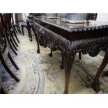 A mahogany sidetable with rectangular top, gadroon border, the apron with carved decoration of lions