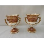 A pair of Copeland Spode urns, iron red and gold decorated flowers, white body with gilt decoration,