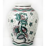 A modern Poole Pottery baluster form vase painted flowers and scrolls in green, black and ochre,