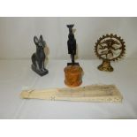 A basalt model of an Egyptian cat, an Egyptian bronze model of a Goddess on a wooden base, a brass