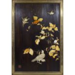 A Japanese panel inlaid in ivory and mother of pearl to birds, flowers, leaves and seed pods, red