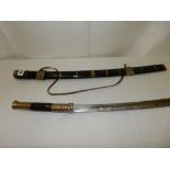 A reproduction Eastern sword in a brass and papier mache bound scabbard