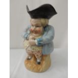 A 19th Century Toby jug with black tricorn hat, blue jacket, yellow waistcoat and pink breeches -