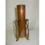 An Art Nouveau style copper and brass vase of cylindrical form with pierced handle supports