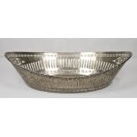 A George V oval bread basket with saw pierced decoration and gadroon border - 12in. wide