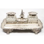 A George III silver desk stand of rectangular form fitted two glass bottles for ink and sand and