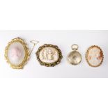A carved shell cameo in a 9ct. gold frame, a larger carved shell cameo and crystal brooch in a