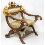 A carved walnut framed throne style chair with gilded cupid decoration to the cresting rail,