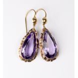 A pair of 9ct. gold and pear drop shaped amethyst earrings