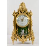 A mantel clock with circular floral swag painted dial, in a gilded ormolu case with Limoges