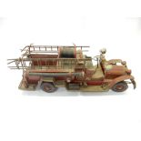 A painted metal model of a vintage fire engine - 20in. wide