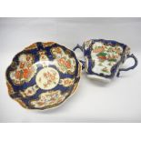 A First Period Worcester twin handled cup and deep saucer decorated in the Imari taste with panels