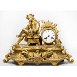 A French mantel clock with white enamel dial, in a gilded ormolu case surmounted by musical trophies