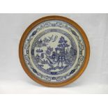 A circular embroidered panel depicting Willow pattern, framed and glazed - 19in. dia.