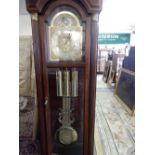 A reproduction American longcase clock with brassed dial, moonphase, striking movement on a gong, in