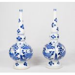 A pair of Chinese Kangxi period rosewater sprinklers of pear shape with elongated necks, standing on