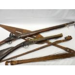 An ornamental rifle, a blunderbuss, a carved wood tribal spear and a whisk