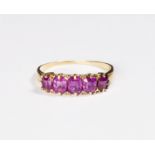 A lady's ring set five rubies, on a gold shank