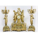 A large French mantel clock with circular enamel dial, in a gilded spelter case surmounted by two