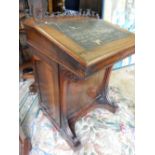 A 19th Century rosewood Davenport with ornate gallery, hinged fall front, ink drawer, fitted