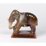 A small polished agate model of an elephant, on rectangular base - 1 3/4in. high